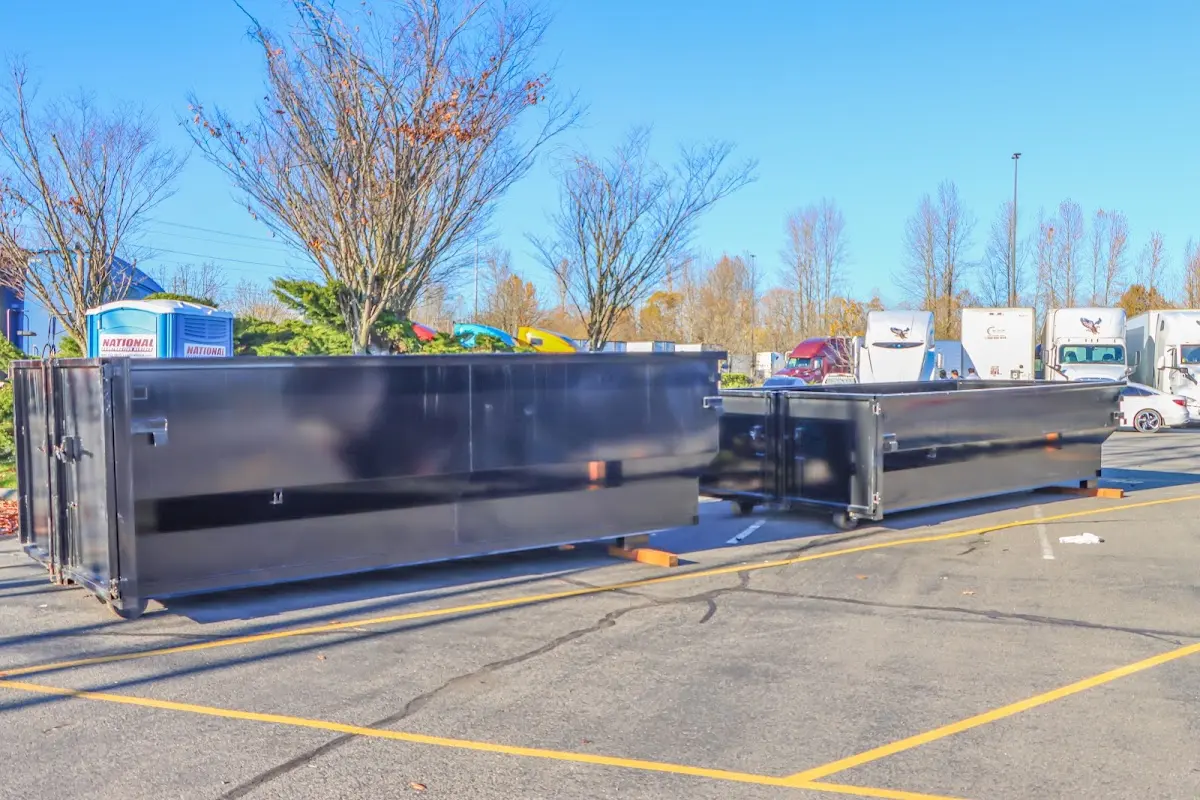 Professional dumpster rental service with roll-off container on residential driveway in Waldorf